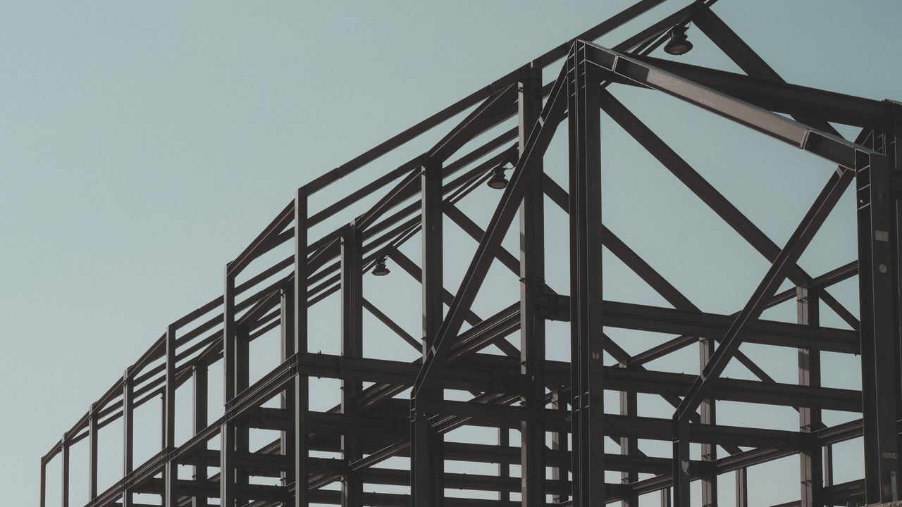 Structural steel frame against a clear sky