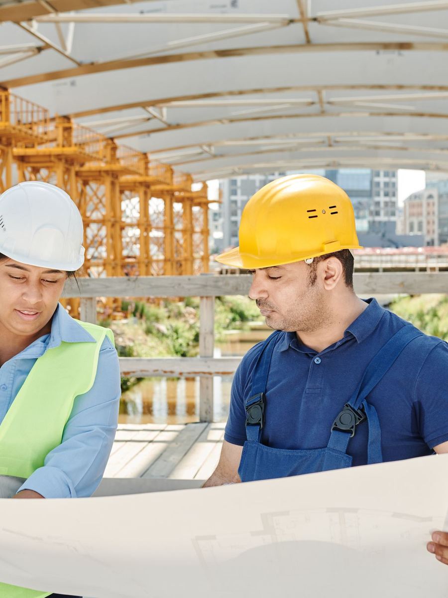 Construction managers reviewing blueprints